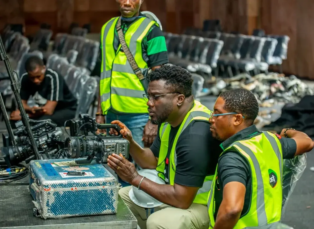 IBST production crew preparing camera equipment at a live event